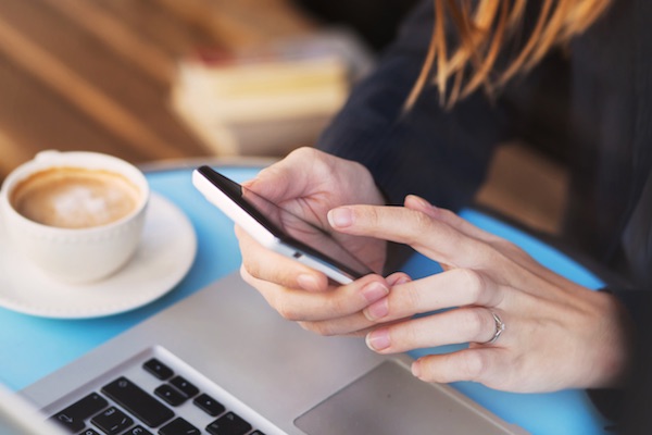 mobile apps on a touchscreen phone in a cafe setting