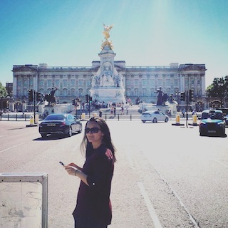 Ariana standing in front of Buckingham palace