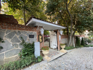 Entrance to a courtyard flanked by a stone wall