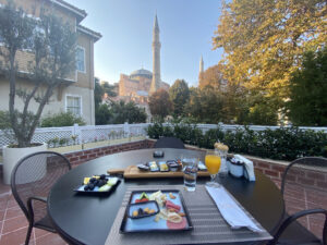 Outdoor patio with a Turkish breakfast spread, overlooking Hagia Sophia in Istanbul