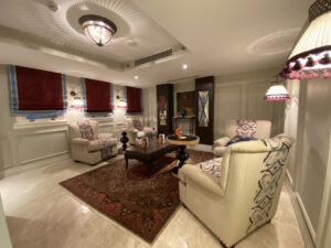 Lounge area with a red Turkish rug and plush chaise seating