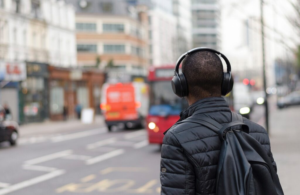 a man wearing noise-cancelling headphones on his back