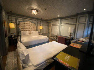 Istanbul hotel room with plush headboard, blue wall paneling and a rolling bed