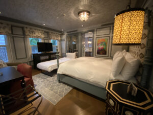 Istanbul hotel room with plush headboard, herringbone floors and blue wall paneling