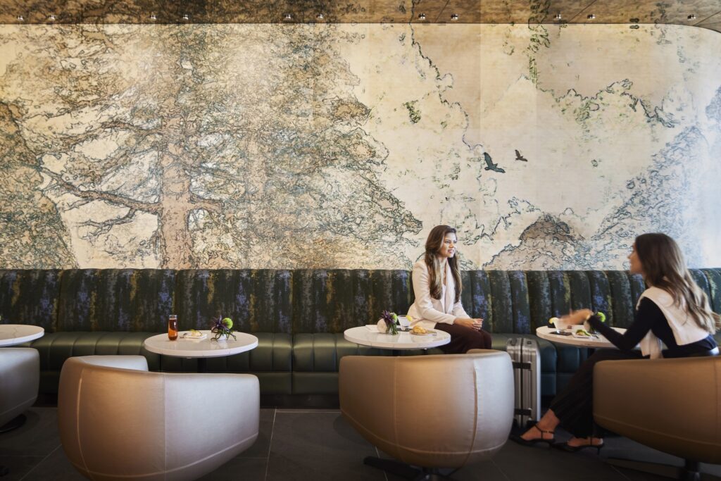 a group of people sitting at tables in a restaurant