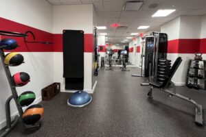 Sparse hotel gym with weights and pilates mat